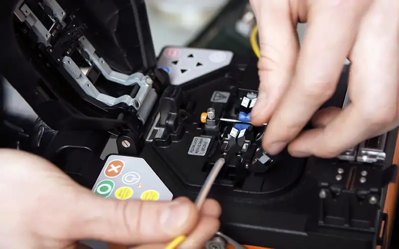 Hands working on splicing fiber